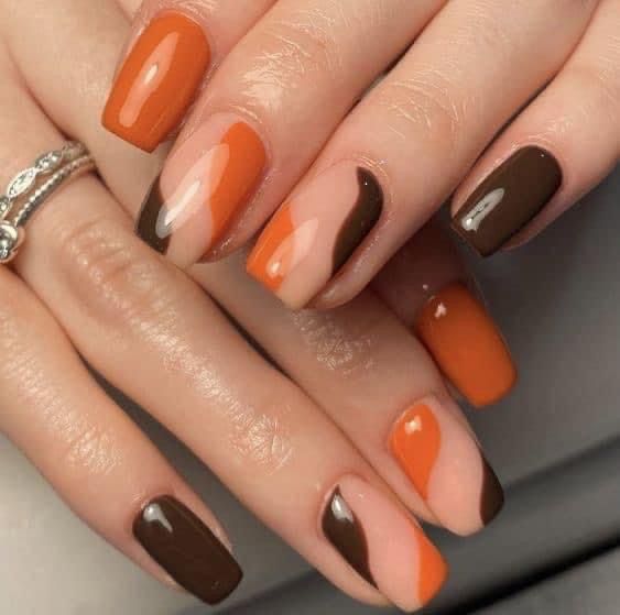 Glänzendes Nageldesign in verbranntem Orange und Braun